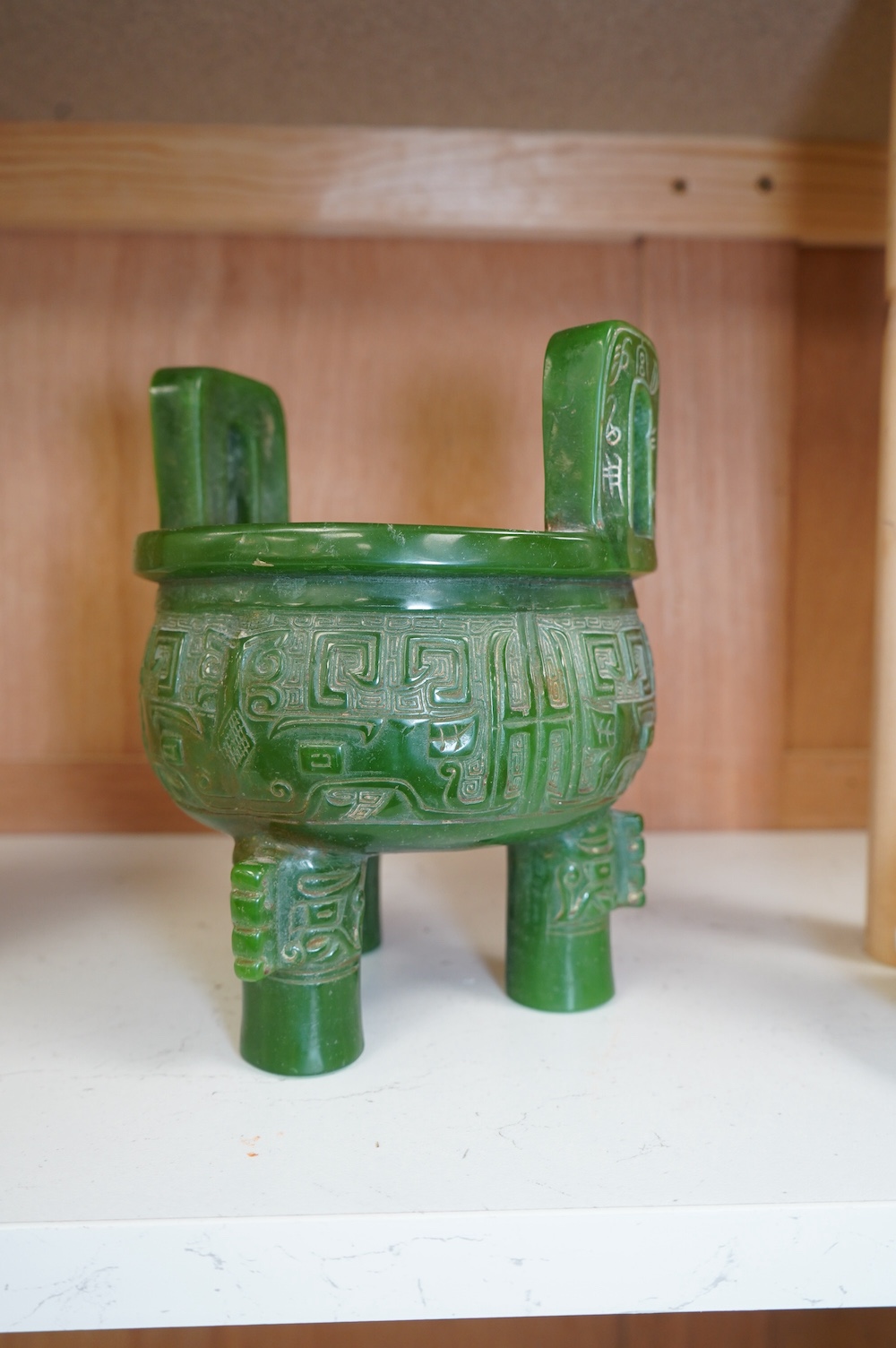 A Chinese green glass tripod censer, 20cm high. Condition - fair